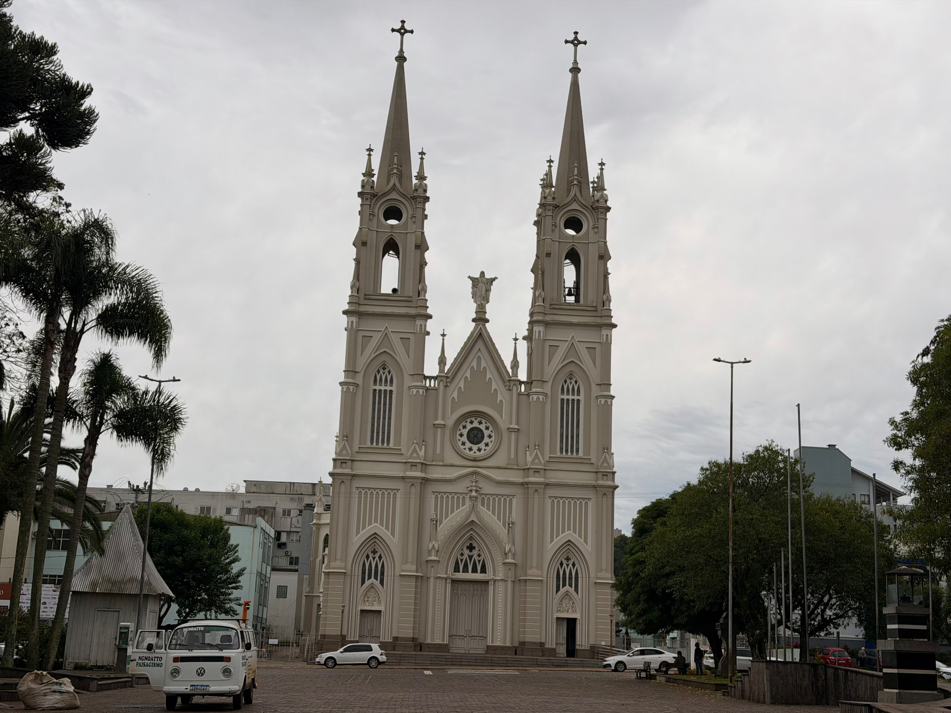 Fachada da Igreja Matriz Santo Antônio vista da praça, com veículos estacionados