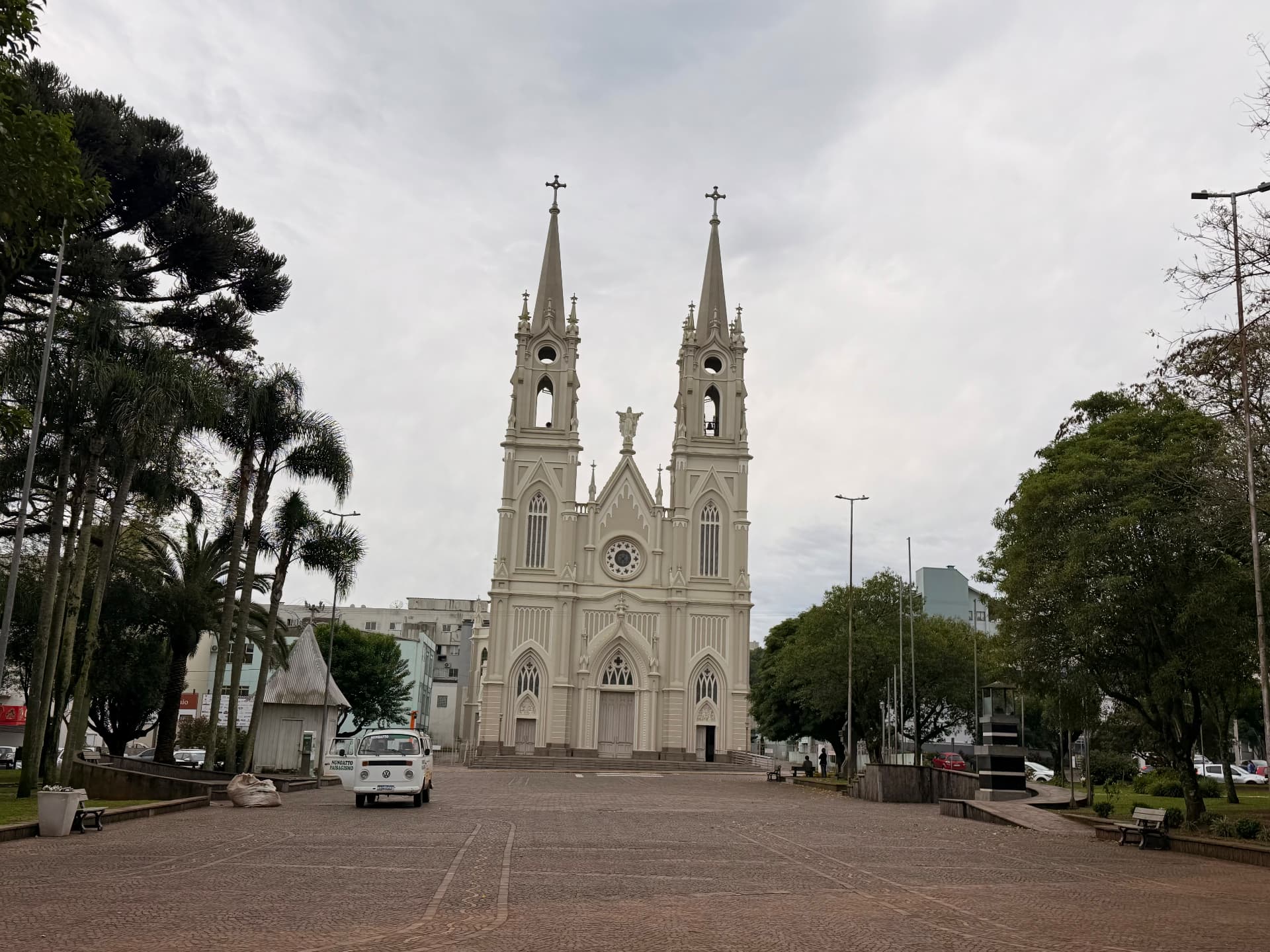 Vista horizontal ampla da Igreja Matriz Santo Antônio e da praça com árvores